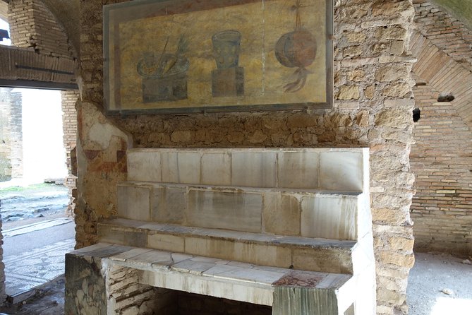 Ancient Ostia Antica Semi-Private Day Trip from Rome by Train with Guide - The Amphitheater and Forum Corners: Seeing Power Up Close